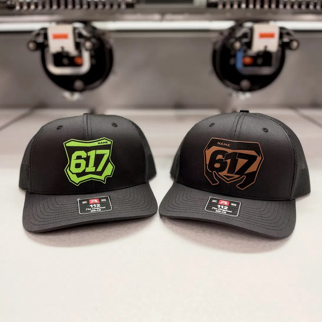 Kawasaki and Suzuki number plate patch hats side by side