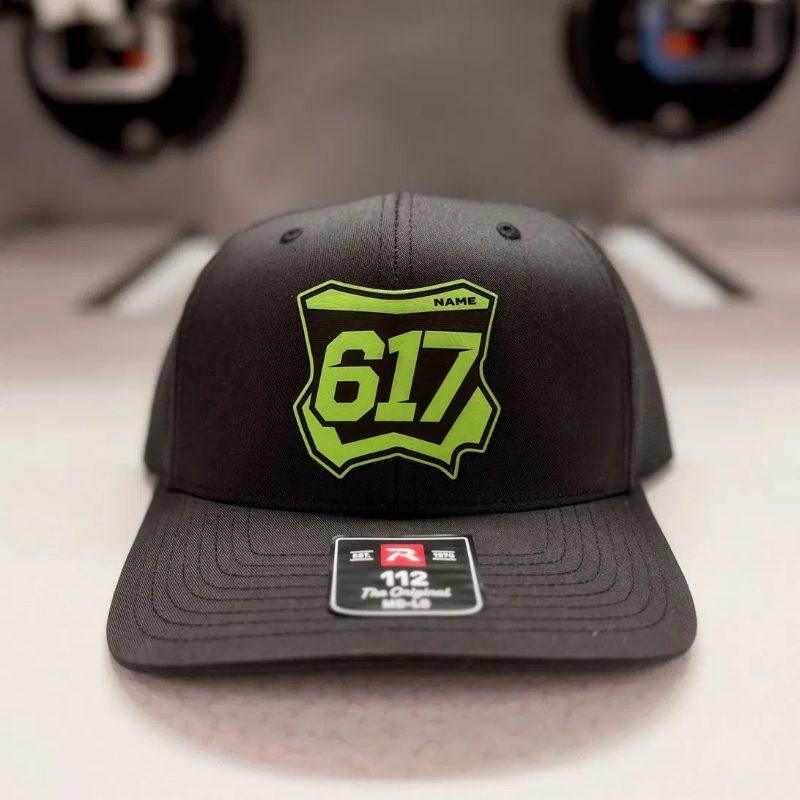 Black trucker hat with a lime green Kawasaki number plate patch